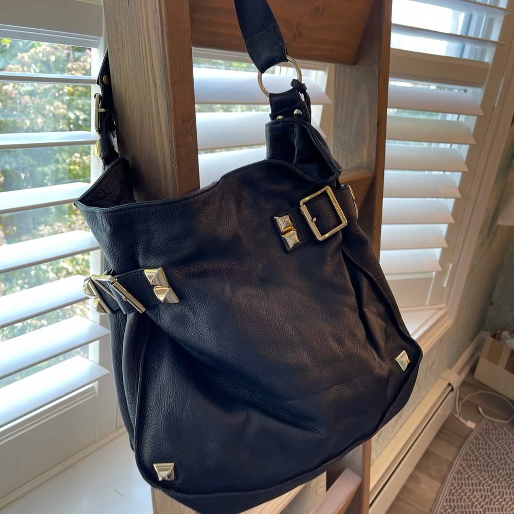 Navy blue Vince Camutto hobo bag.  With gold studs.